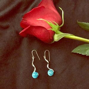 Spiral earrings with blue stone